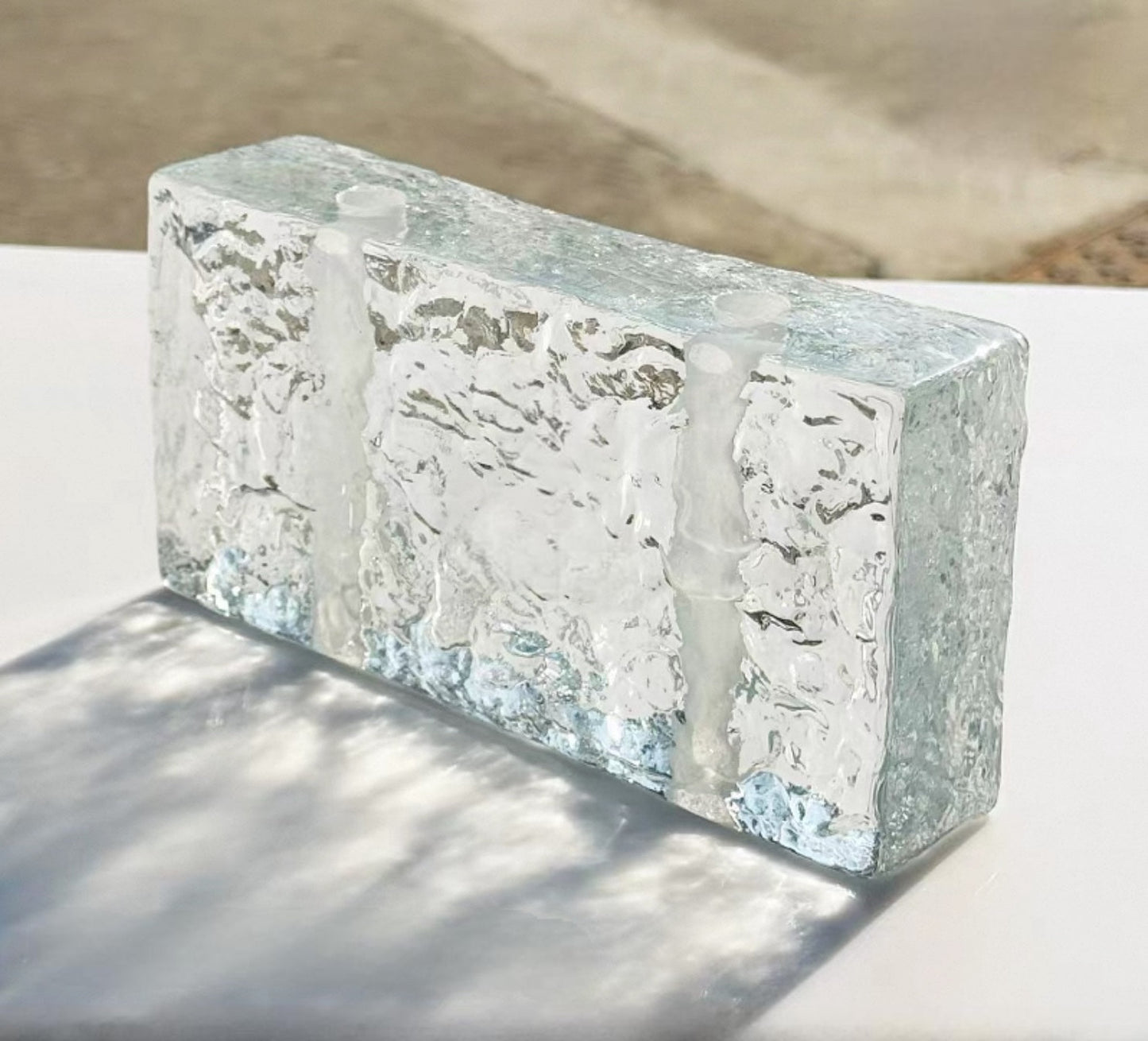 Perforated Glacier glass brick with ice texture and mounting holes by MIOLISM