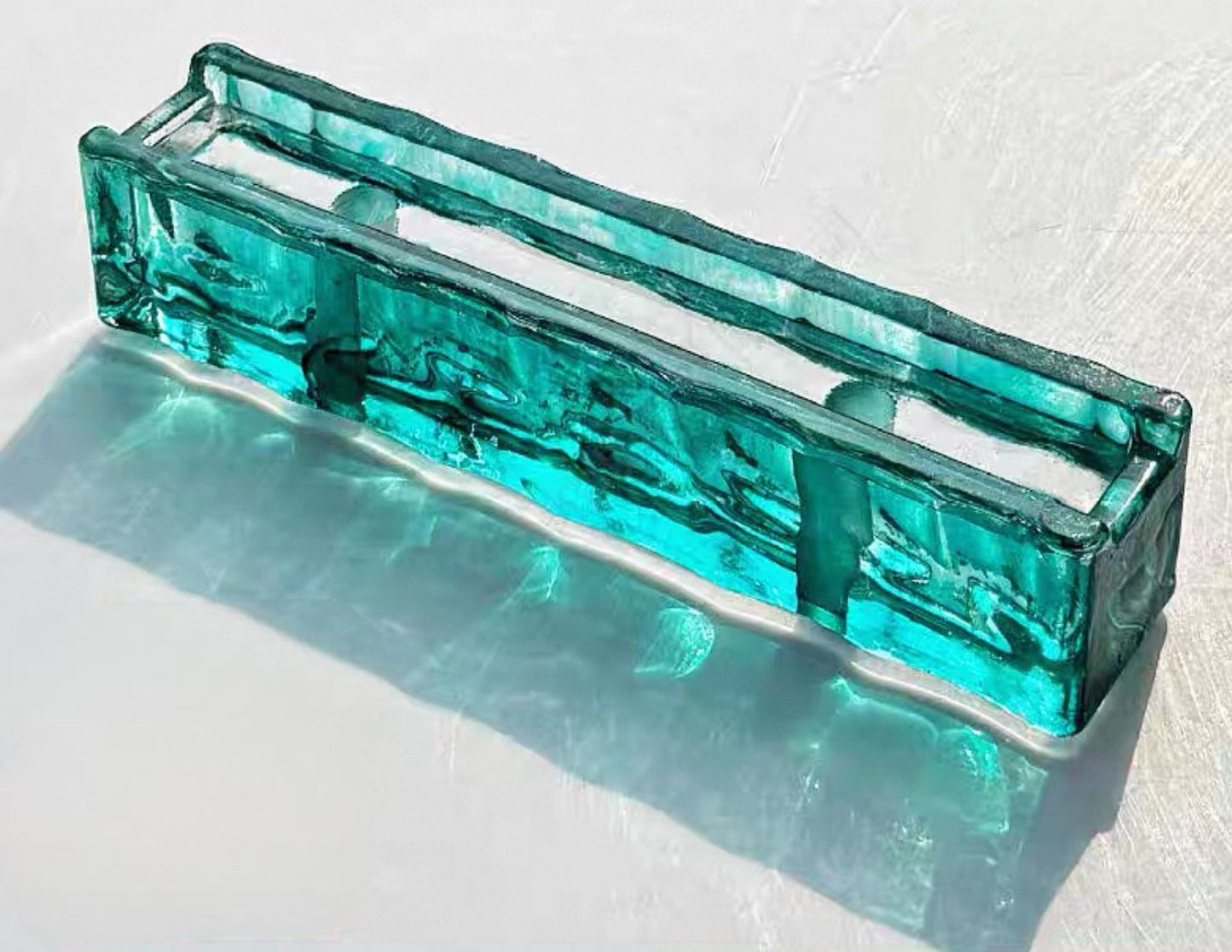Perforated Ripple Emerald green glass brick with flowing texture by MIOLISM