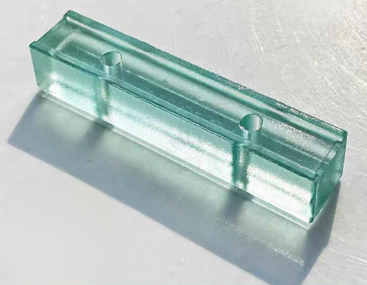Perforated Orange Peel Ice Jade glass brick with soft green texture by MIOLISM