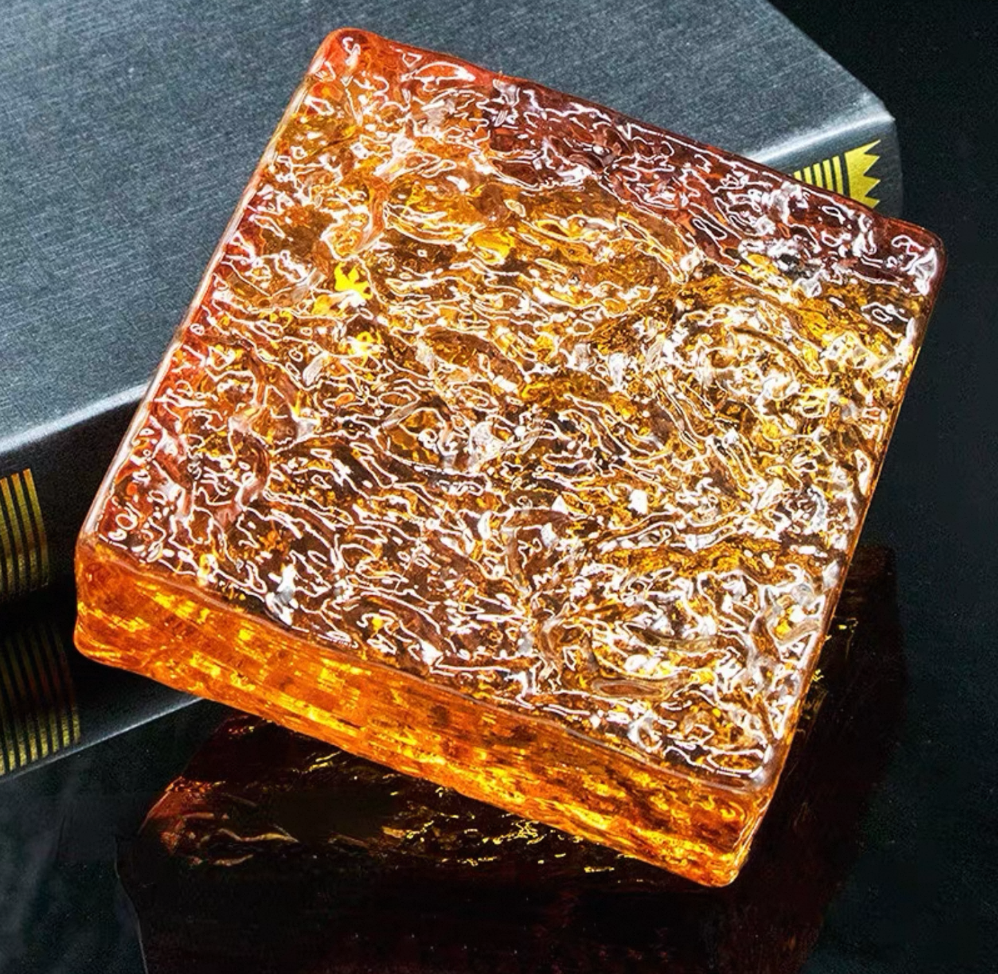 Ice Crystal Molten Amber orange glass brick with rugged textured surface by MIOLISM