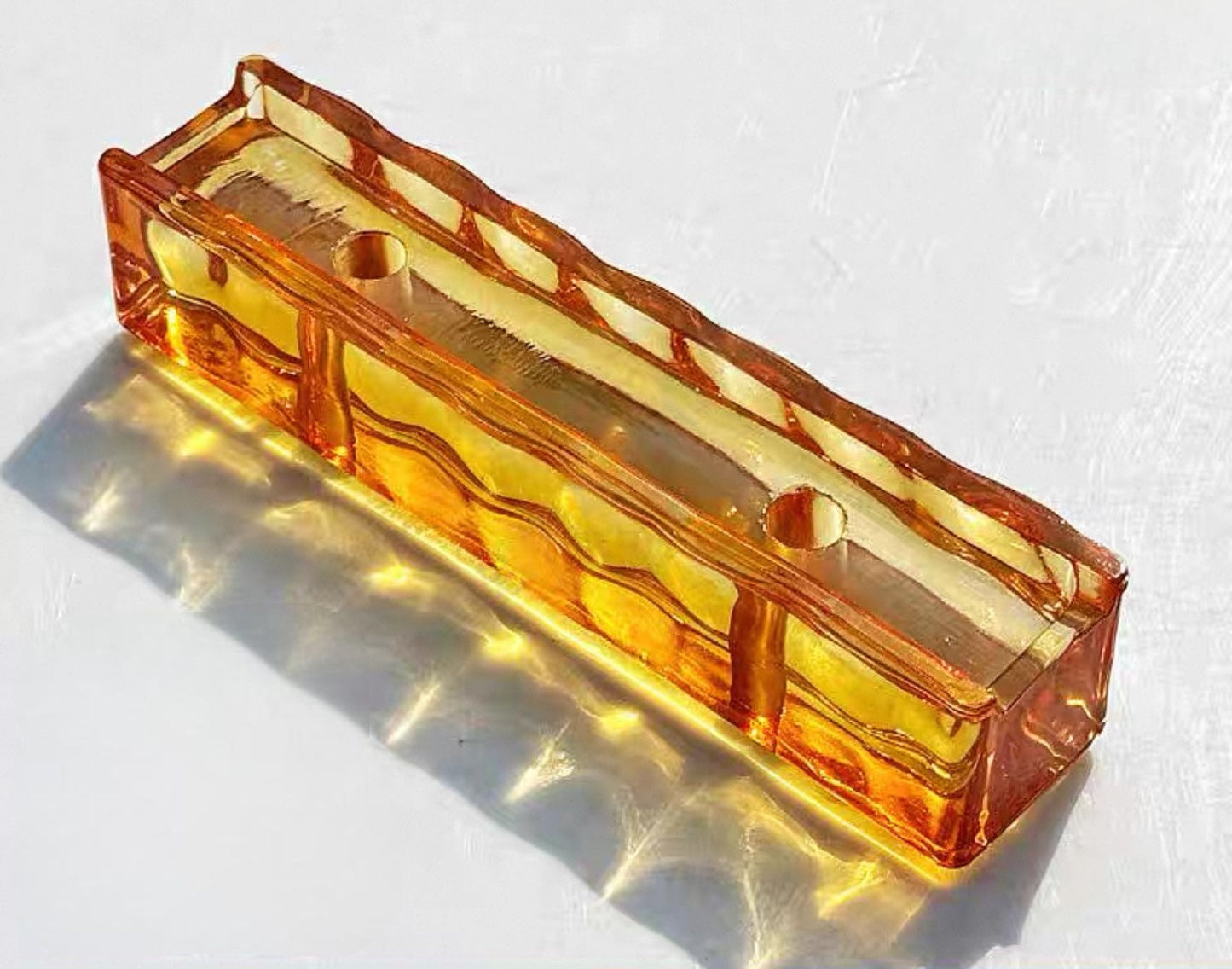 Perforated Ripple Sunstone orange glass brick with warm wave texture by MIOLISM