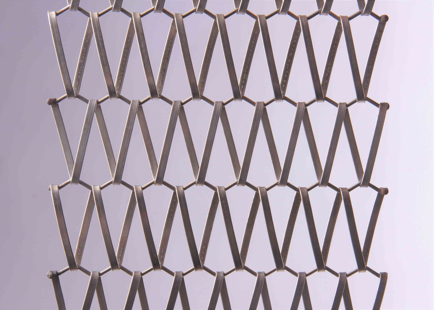 Metallic mesh pattern on a light gray background