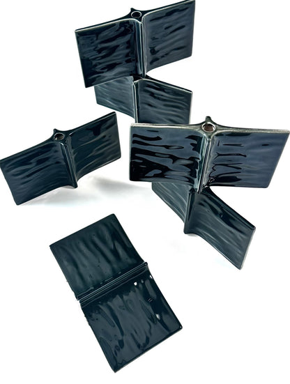 Set of black rectangular pouches with zippers on a white background