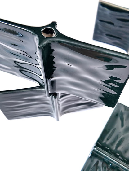 Metallic butterfly-shaped object on a white background