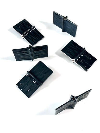 Set of black plastic components on a white background