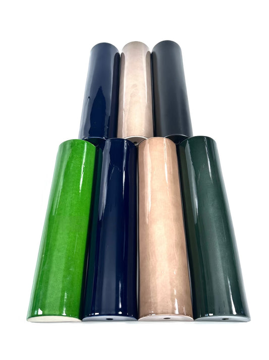 Five rolls of vinyl wrap in green, blue, and beige on a white background