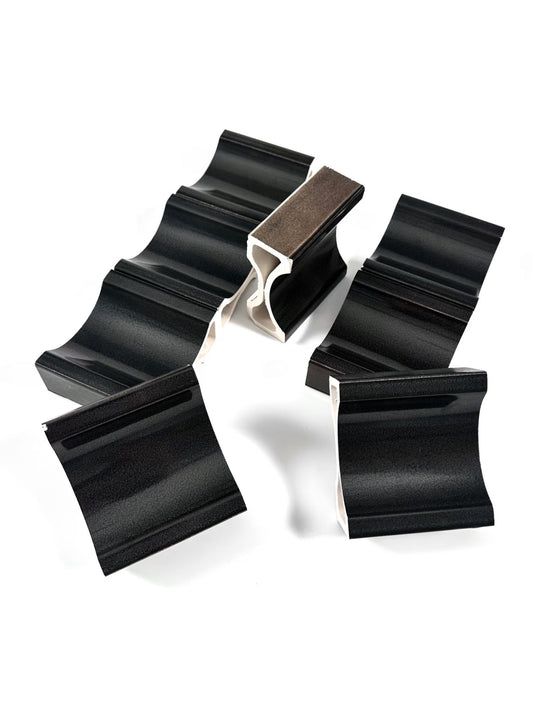 Detailed view of MIOLISM Fluted Crest tile showing tiered ridged profile and graphite metallic mineral texture.