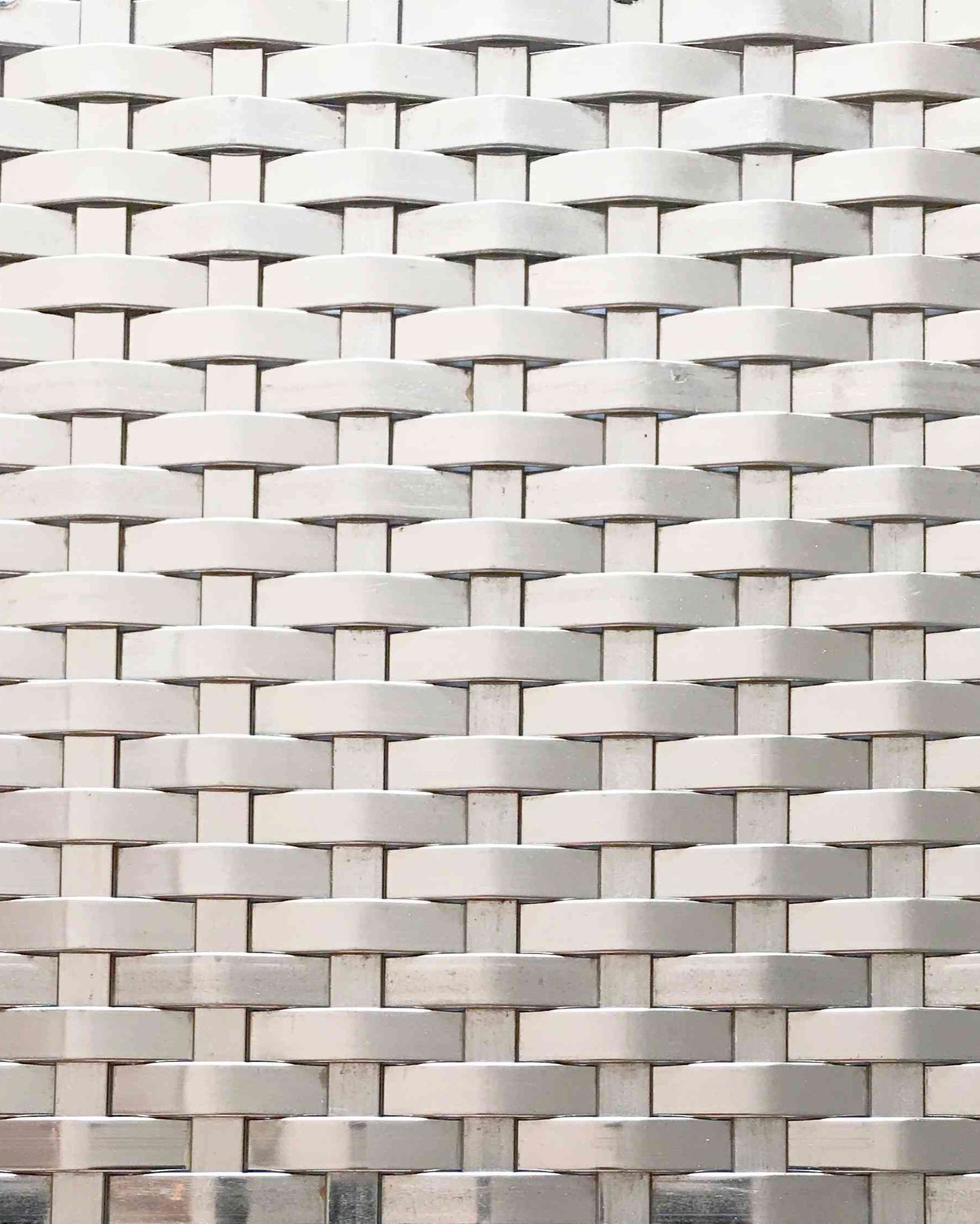 Close-up of a woven pattern with interlocking rectangular shapes in neutral tones.
