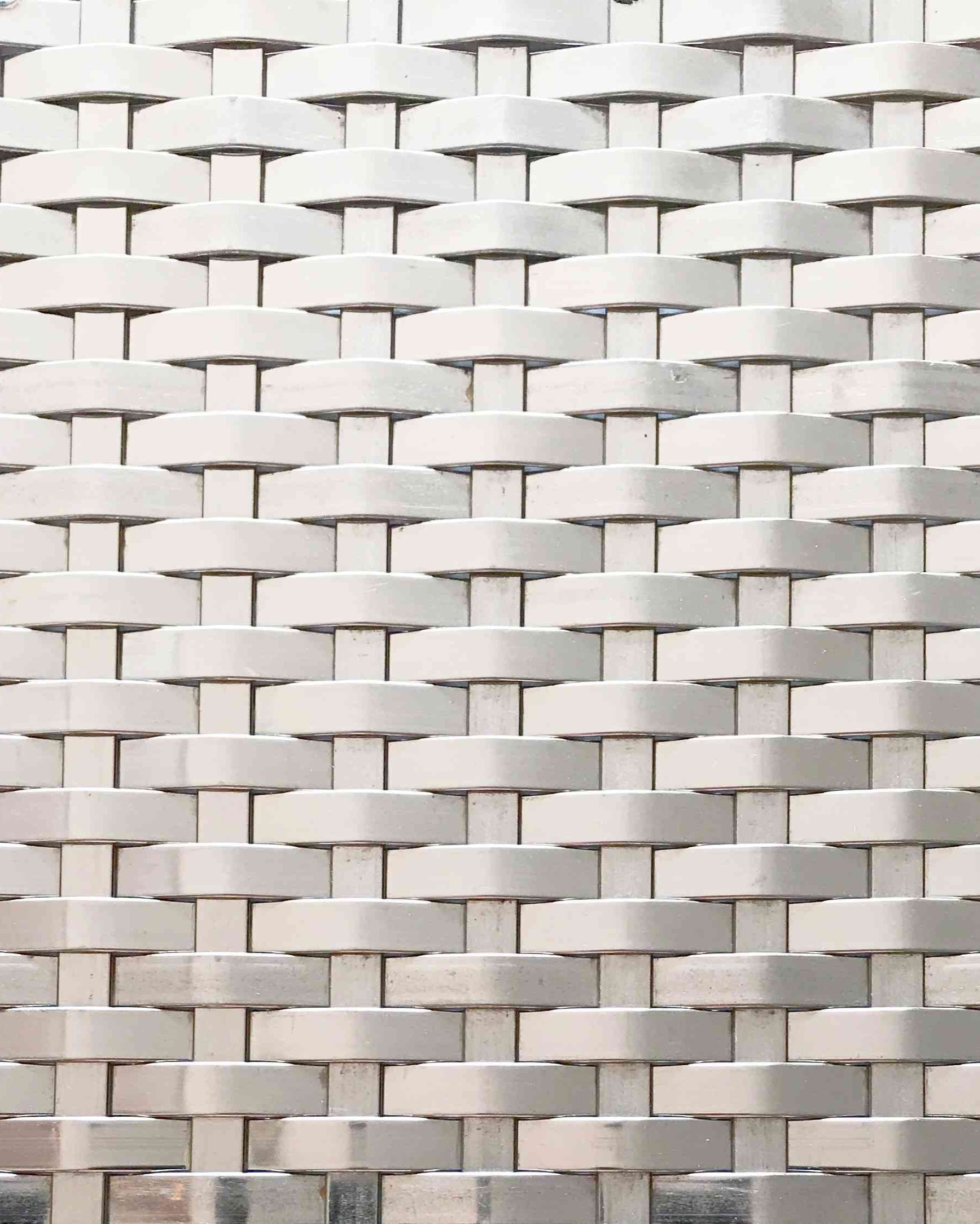 Close-up of a woven pattern with interlocking rectangular shapes in neutral tones.