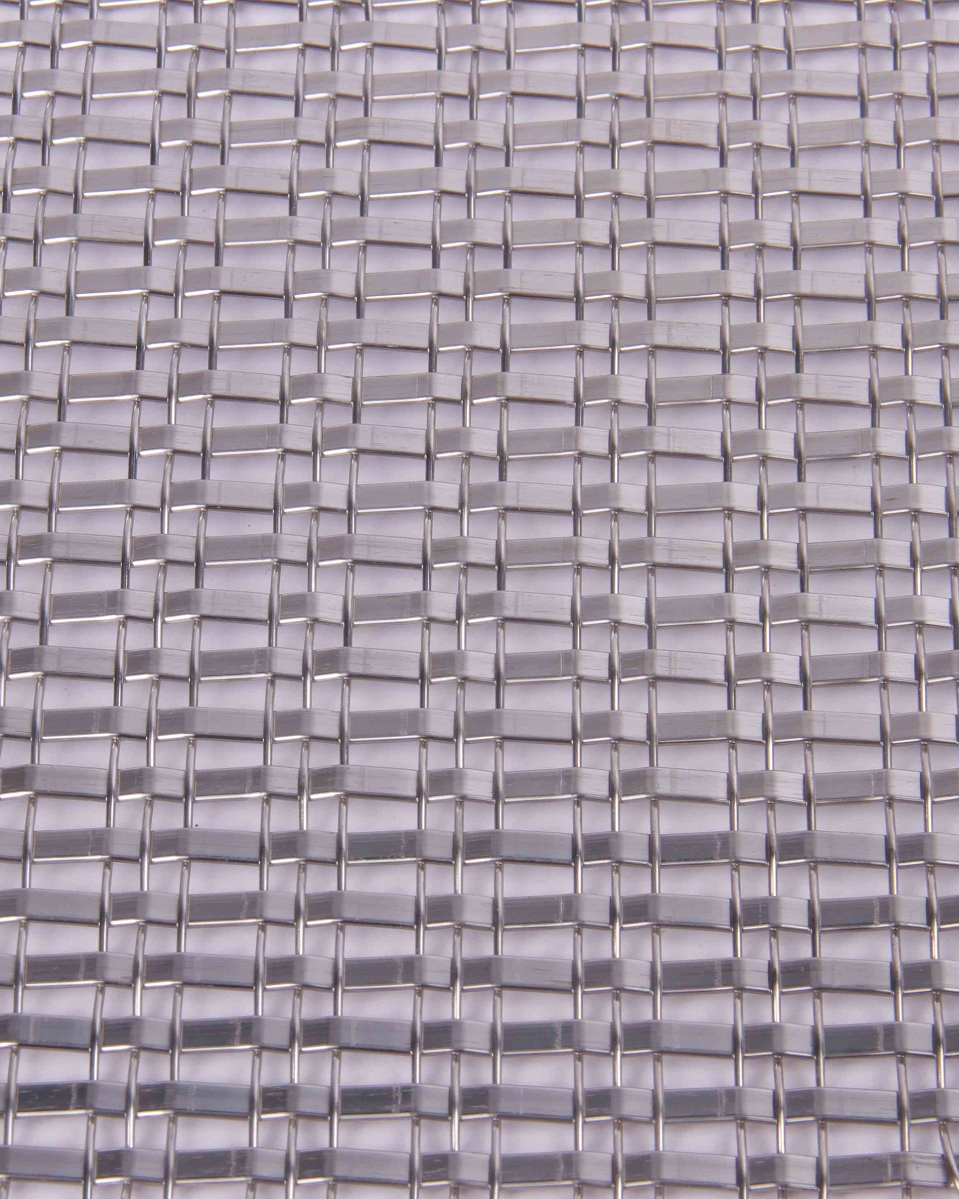 Close-up of a woven pattern with interlocking rectangular shapes in gray tones.