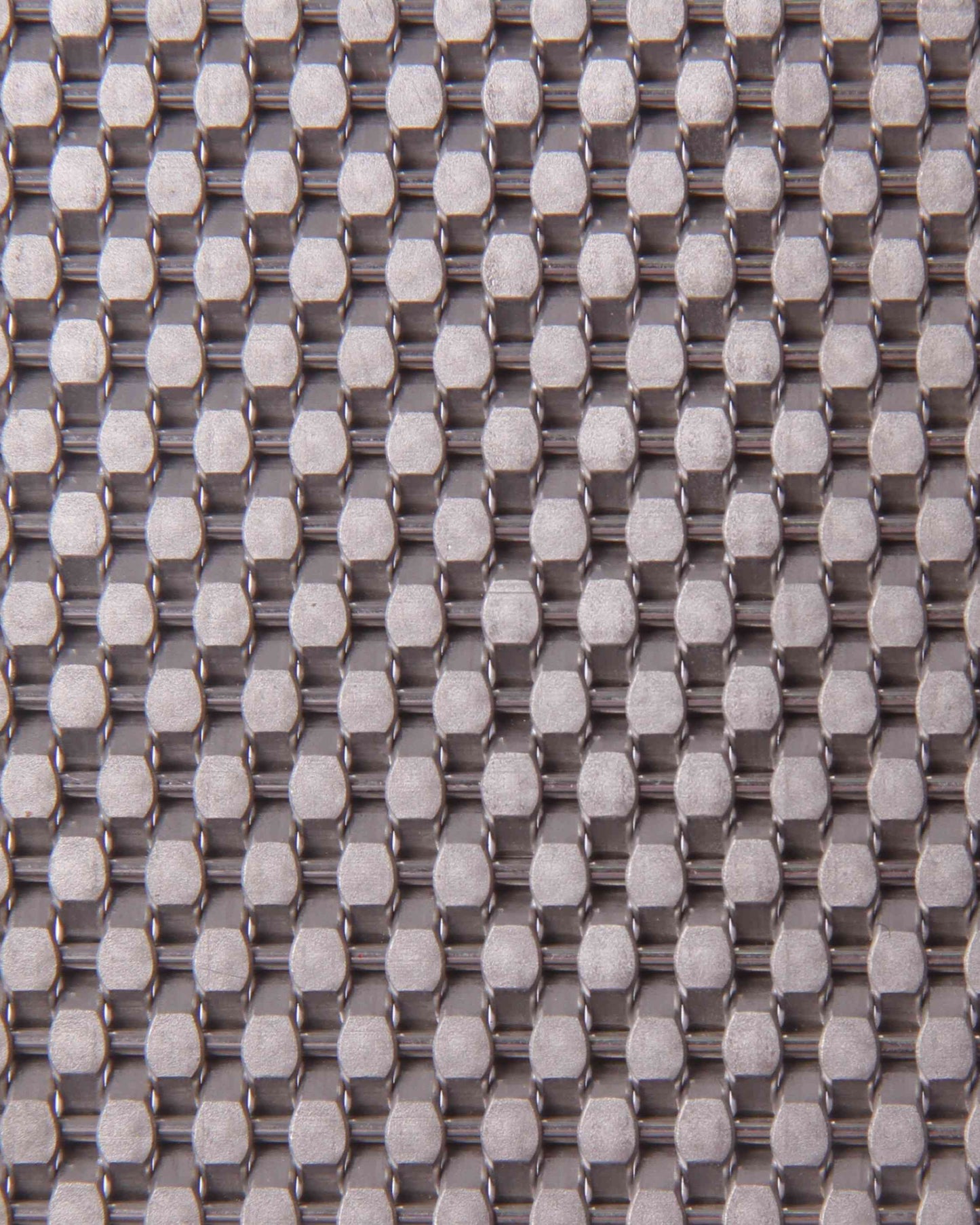 Close-up of a textured fabric with a grid pattern in gray and white.