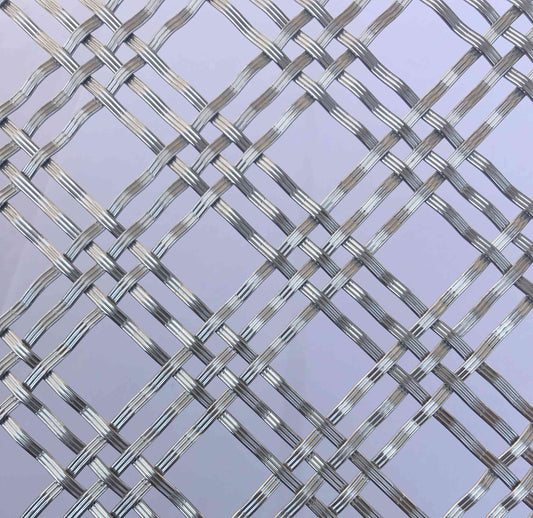 Metallic woven mesh on a light purple background
