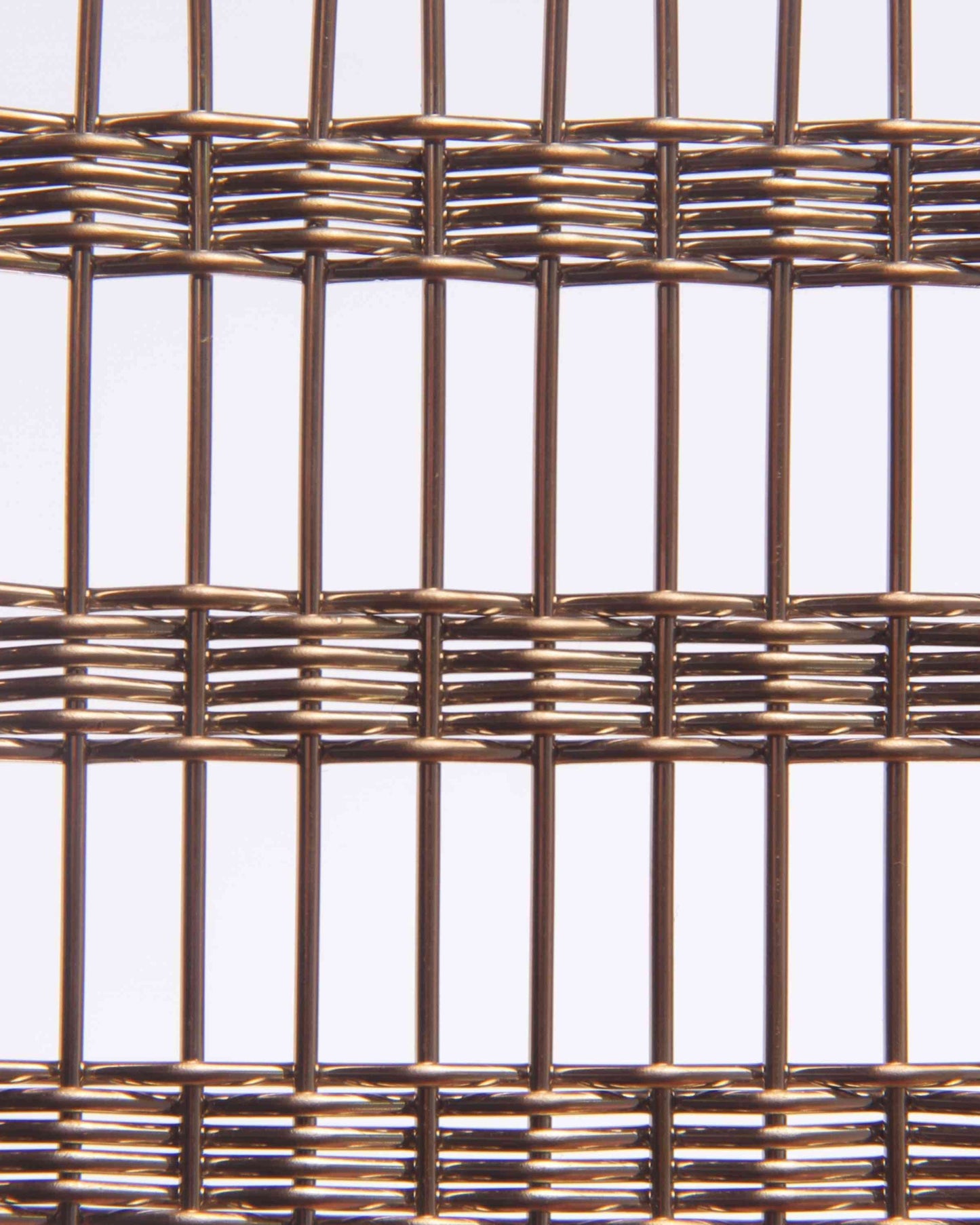 Close-up of woven metal mesh on a light gray background