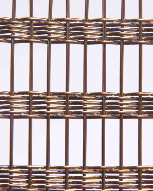 Close-up of woven metal mesh on a light gray background