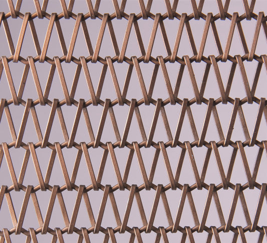 Close-up of a metal mesh with a geometric pattern on a gray background