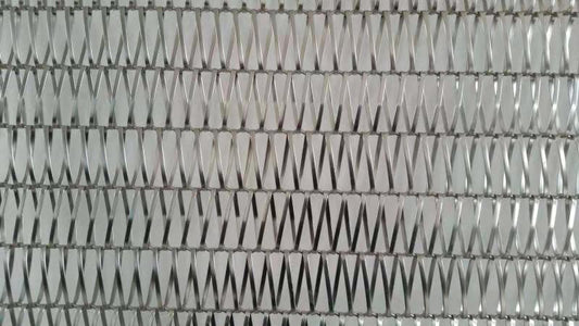 Metallic textured pattern with a zigzag design on a gray background