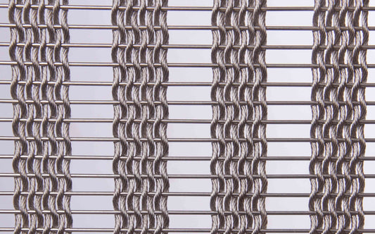 Close-up of a metal wire mesh with a grid pattern on a light gray background